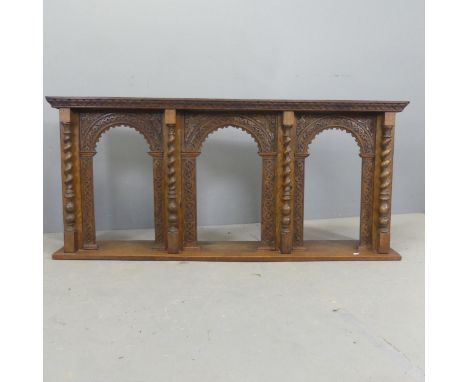 An early 20th century carved oak hanging shelf. W141cm, H64cm, D23cm. 