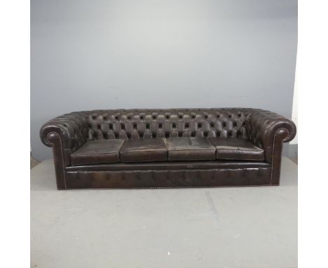 A modern button-back studded brown leather upholstered four-seated Chesterfield sofa. Overall: W250cm, H70cm, D90cm. Seat: W1