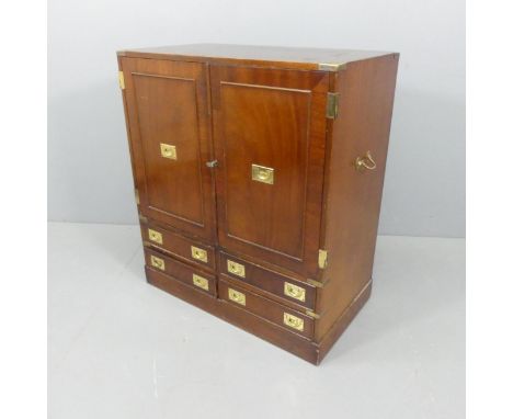 A vintage mahogany cabinet, the two cupboard doors and 4 short drawers featuring campaign style handles. W86cm, H96cm, D46cm.