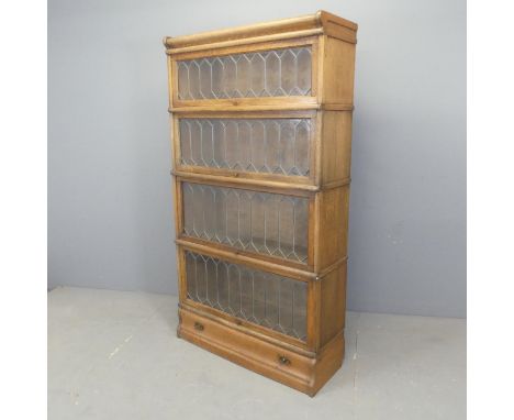 An early 20th century oak Globe Wernicke style four shelf sectional stacking bookcase, in six sections with drawer to base. W