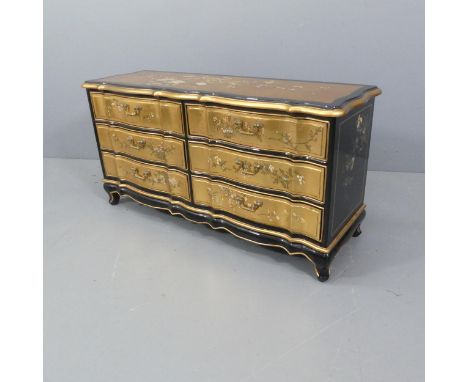 A modern black lacquered side-by-side chest of six drawers, with gold leaf and Chinoiserie decoration, and raised on cabriole