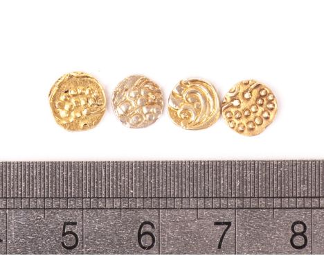 A group of four ancient gold coins, one having elephant design, two with stylised T or arrow, the other with sythe and pellet