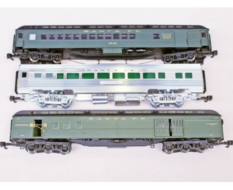 A group of three Aristo-Craft G scale model railway Santa FE carriages