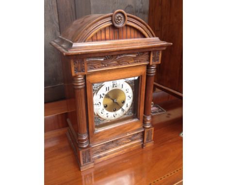 An oak mantle clock with silvered brass dial