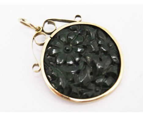 A carved jade pendant in 9ct gold mount, length 4cm