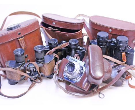 A pair of bausch & Lomb binoculars, the leather case having fitted compass, together with two other pairs and a Voigtlander c