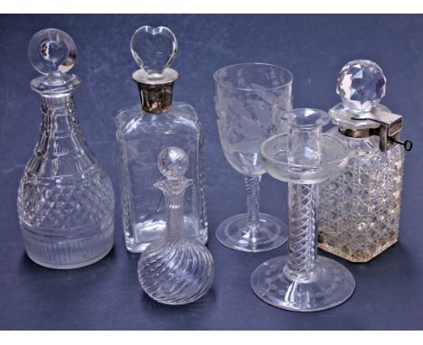 A group of glass comprising a decanter with hallmarked silver collar, a decanter with hallmarked silver locking mechanism and