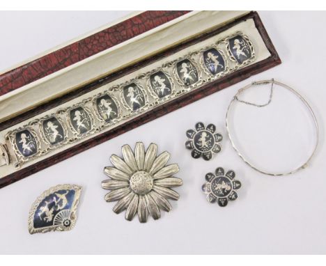 A group of silver jewellery comprising a bangle, a flower brooch and a Siam bracelet with matching earrings and brooch