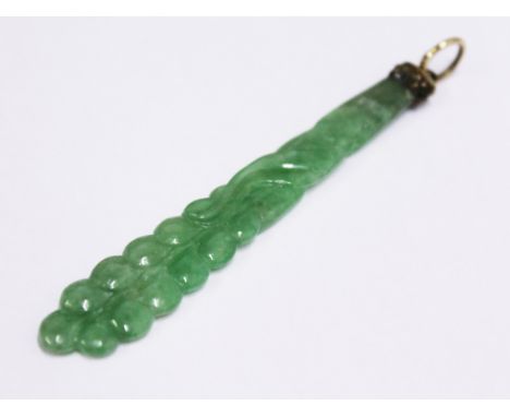 A carved jade pendant with yellow metal mount, length 8.5cm, with associated box