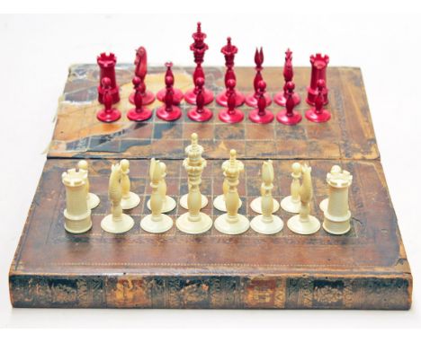 An ivory chess set with folding chess board. Condition - red rook, knight and bishop with damage (see images), minor chips to