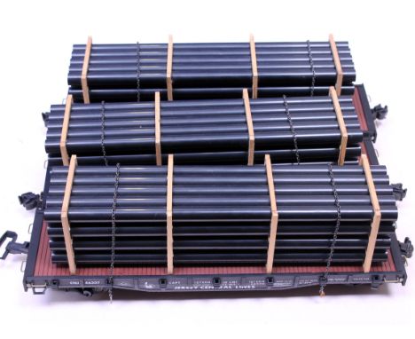 A group of three Aristo-Craft G scale model railway shipping cars