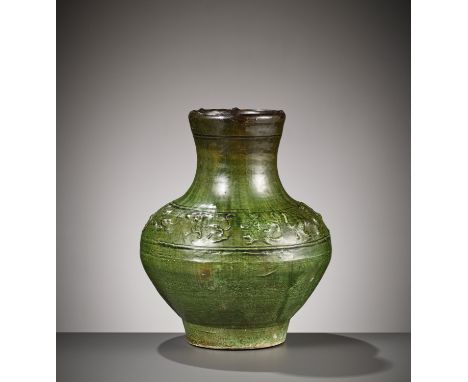 AN EMERLAD-GREEN GLAZED 'HUNTING SCENE' POTTERY VASE, HAN DYNASTY 漢代綠釉狩獵紋雙輔首陶瓶China, 206 BC to 220 AD. Of compressed globular