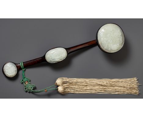 A PALE CELADON JADE-MOUNTED WOOD RUYI SCEPTER, QING DYNASTY 清代青玉三鑲嵌木製如意China, 19th century. The hardwood frame inset to eithe