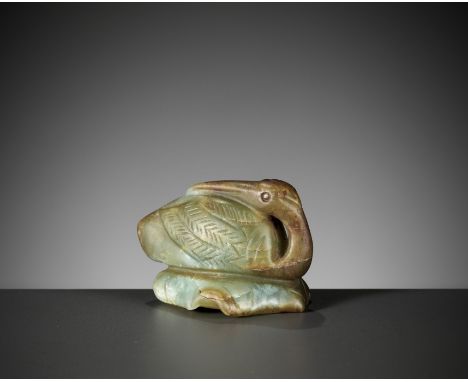 A CELADON AND RUSSET JADE FIGURE OF A CRANE, MING DYNASTY 明代青玉留皮仙鶴擺件China, 1644-1912. The bird perched on a lotus leaf with t