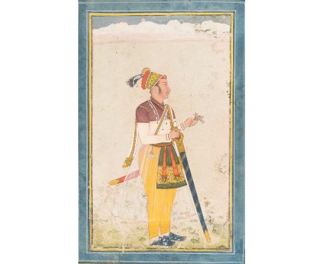 AN INDIAN MINIATURE PAINTING OF A PRINCEIndia, 19th century. Gouache, ink and gold color on paper. Standing sideways in an op