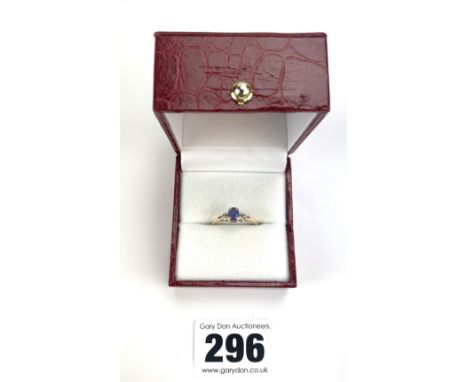 14k gold ring with purple stone, size J, w: 1.3 gms