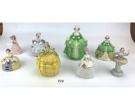 5 trinket boxes, 1 pin cushion doll and 2 foreign figures. Largest 7.5" high. Top of large yellow trinket box has been repair