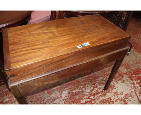 A George III mahogany Bagatelle table, circa 1800, with a quantity of ivory balls and two associated cues