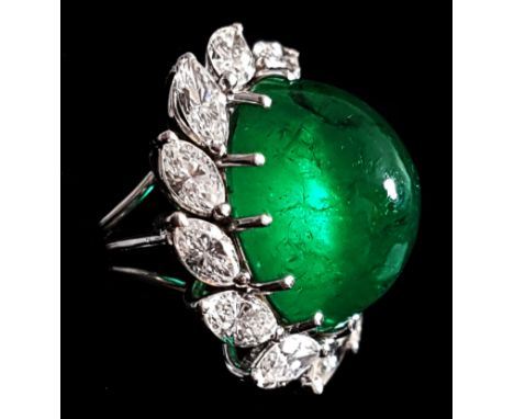 A fine 1950's Columbian emerald and diamond cluster ring, the oval cabouchon emerald of good colour and purity weighing appro