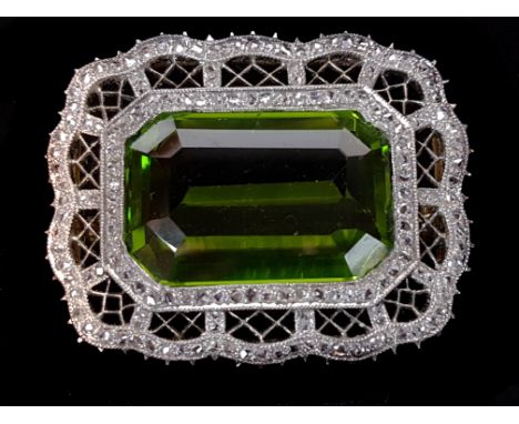 An antique belle epoque peridot, platinum and rose cut diamond brooch, c1905, possibly Russian, set to the centre within a re