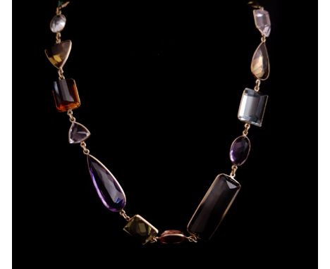 A striking 18ct yellow gold and multi gem set  long chain,  composed of thirty six various shaped spectacle set gemstones inc