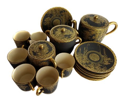 A Japanese satsuma tea service, black ground over gilded with flowering wisteria vines, comprises teapot and cover, milk jug 