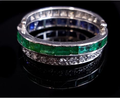 An Art Deco diamond, emerald and sapphire triple hoop 'day and night' swivel ring, mounted in platinum, the centre band set w