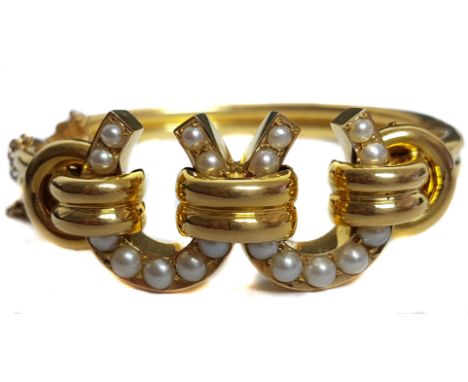 A very fine quality antique natural pearl and 18ct yellow gold bangle, c1888, the modern design bangle composed of two natura