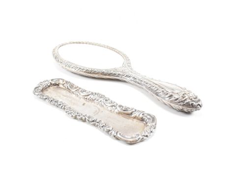 A Victorian hallmarked silver mounted hand mirror and hair pin dish. Both&nbsp;having scrolled floral repousse designs. The v