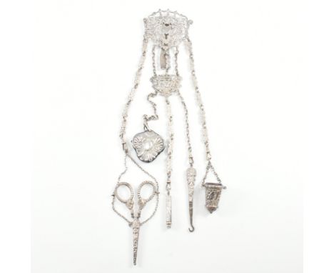 A 19th century Victorian hallmarked silver chatelaine. The chatelaine having a pair of scissors, button hook, pin cushion pad