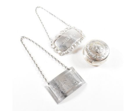 Two 20th century hallmarked silver decanter labels and a pill box. The lot to include two decanter labels with one being of r
