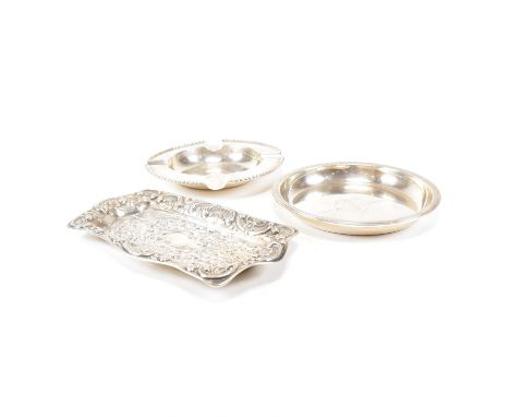 Three hallmarked silver dishes and trays. The silver to include an Edwardian hallmarked&nbsp;repouss&eacute; decorated card t