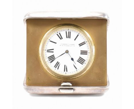 An early 20th Century silver hallmarked travel clock. The clock having a silver case with striped engraved details and round 