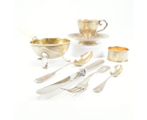 An 800 silver and gilt metal breakfast set. The set comprising of eight pieces including a tea cup and saucer, napkin ring, c