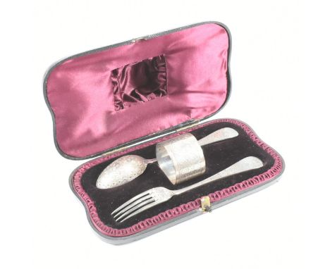 A Victorian hallmarked silver cased christening set. The set consisting of a hallmarked silver spoon, fork and napkin ring wi