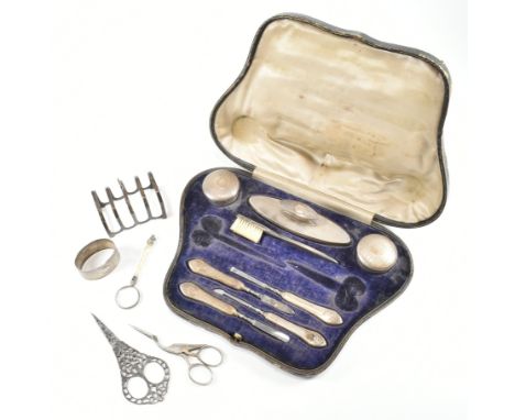 A collection of early 20th century hallmarked silver and white metal items. To include a vanity case with silver handled and 