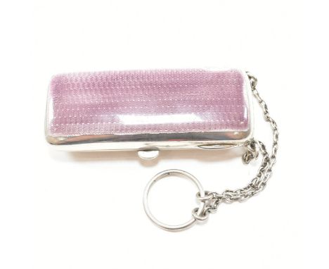 A George V hallmarked silver and enamel cigarette and compact case. The combination case having a mauve guilloche hinged lid.