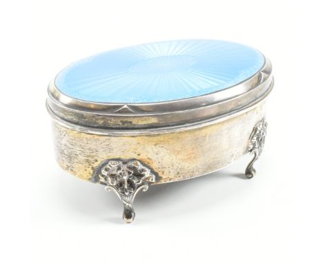 A George V hallmarked silver and enamel jewellery box. The jewellery or trinket box having a blue guilloche enamel lid with f