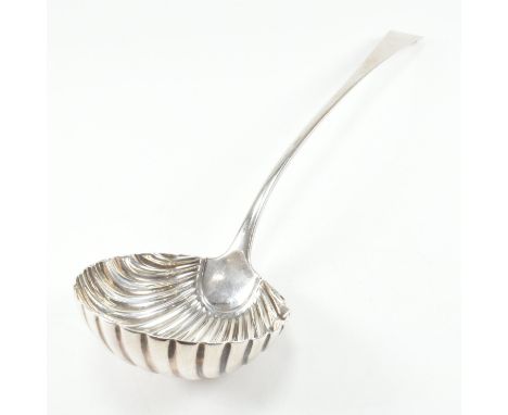 A George III hallmarked silver shell bowl ladle. The Georgian ladle having a scalloped bowl. Hallmarked for London. Date lett