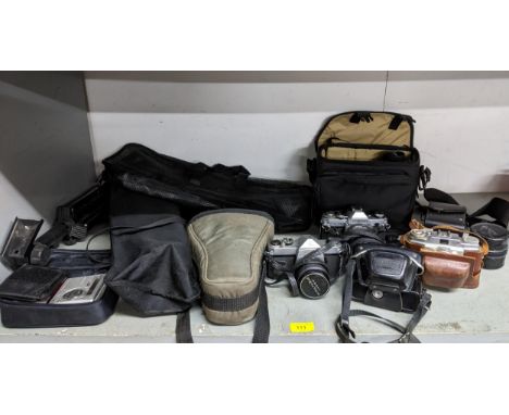 A selection of vintage film camera equipment and accessories to include a Canon AE-1 camera in case with lens, an Asahi Penta