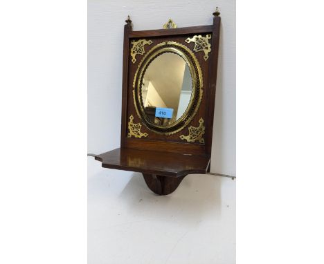 An early 20th century oak and brass bracket with a mirrored back and folding shelf, 42cm x 21cmLocation:RAB 