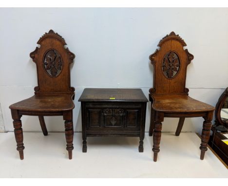 A pair of Victorian carved oak hall chairs S/F and an early 20th century oak chest of small proportions, Location: 