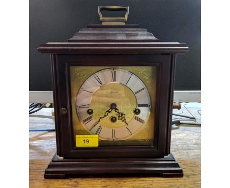A late 10th century C Hermle German mantle clock in a mahogany finished case, the face with a Roman dial, Location: 