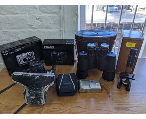 A selection of cameras to include a Minolta xG2 film camera, digital camera, Regent 7 x 50 binoculars and a wooden cased micr