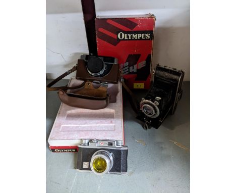 Vintage film cameras to include an Olympus Auto Eye camera with D Zuiko f4.5cm lens, in leather case; a Halina 35X and an Agf