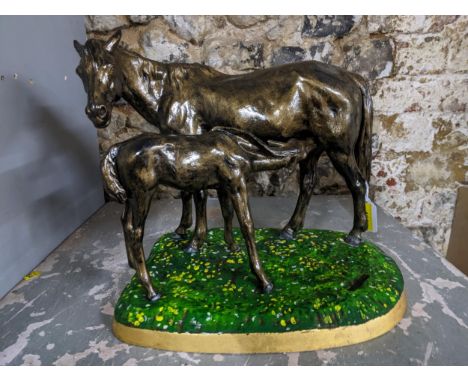 A painted and lacquered cast iron model of a horse and foal, dated 1967 with cast marks to the underside of base. The border 