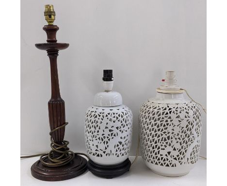 Two Chinese blanc de chine glazed pierced tables lamps together with a mahogany lamp with a fluted columnLocation: 