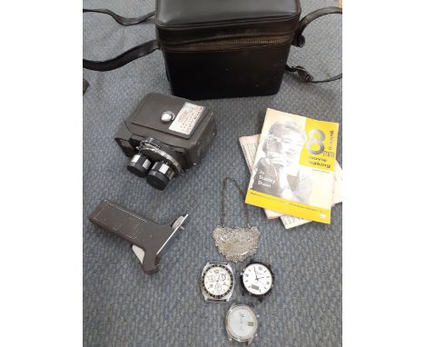 Three gents watch dials, a decorative silver tone whiskey decanter label and a vintage Prinz 8mm movie maker. Location: 