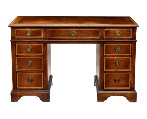 A Georgian style mahogany double pedestal desk, with inset gilt tooled leather, three frieze drawers over two banks of three 