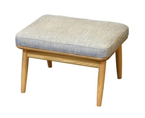 An Ercol Marino ash foot stool, ref. 0701, fabric code E533, raised on splayed turned tapered legs, 24 x 18in. (61 x 45.75cm.